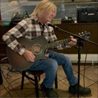 Picture of Chuck Taylor performing on guitar